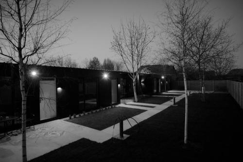 a black and white photo of a courtyard with trees at Pensiune Arada in Arad