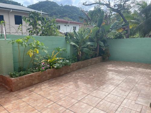 a garden with a fence and a patio at Beverley Manor DIAMOND VALE' 2 Bedroom 1 Bath Apartment in Diego Martin