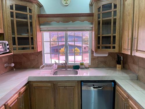 a kitchen with a sink and a window at Beverley Manor DIAMOND VALE' 2 Bedroom 1 Bath Apartment in Diego Martin