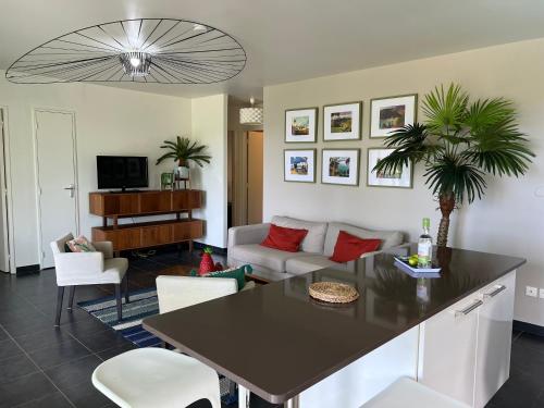 a living room with a table and a couch at EAST KEYS - East Villa Muscade in Le Vauclin