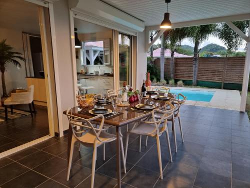 a dining room with a wooden table and chairs at EAST KEYS - East Villa Muscade in Le Vauclin