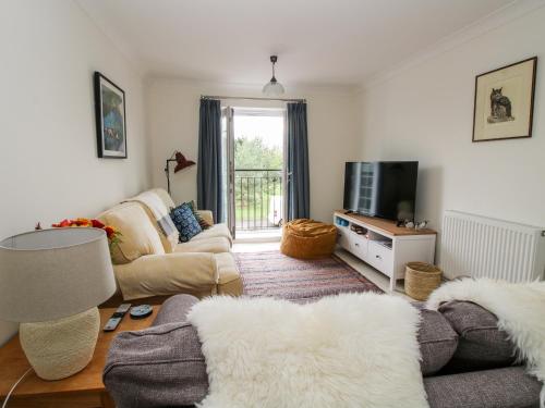 a living room with a couch and a tv at 30 Poplar Close in Shrewsbury