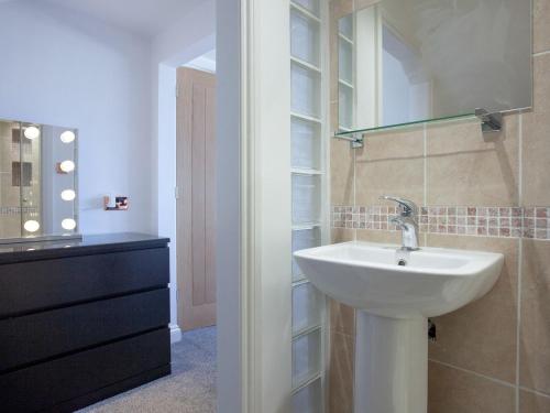 a bathroom with a sink and a mirror at Harbour Heights in Brixham