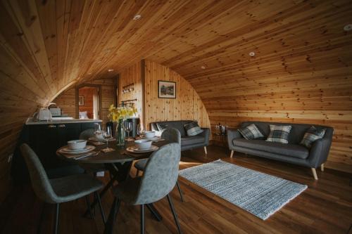 a room with a table and chairs in a cabin at Daffodil in Rhayader
