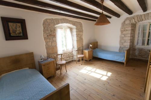 a bedroom with two beds and a window at Holiday Home Mihovilovic in Premantura
