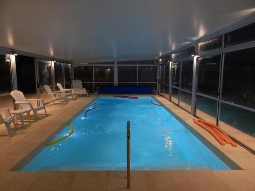 a large indoor swimming pool in a building at Hotel Tamariz in Piriápolis