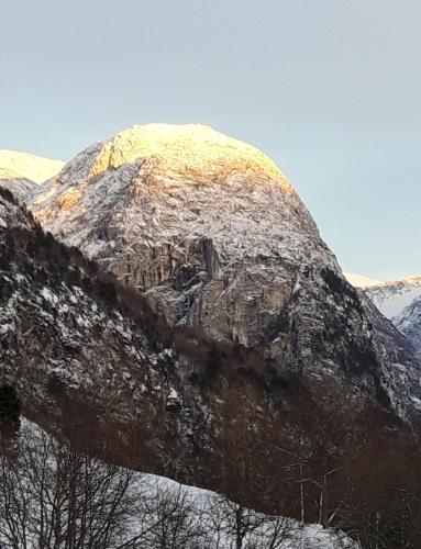 a mountain with snow on top of it at Stalheim Fjord og Fjellhytter in Stalheim