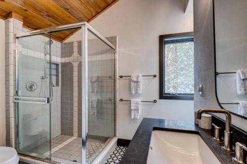 a bathroom with a glass shower and a tub at Bennett Flat Adventure in Truckee