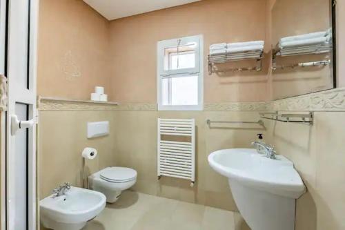 a bathroom with a sink and a toilet and a window at La villa des corsaires, vue panoramique sur Rabat in Sale