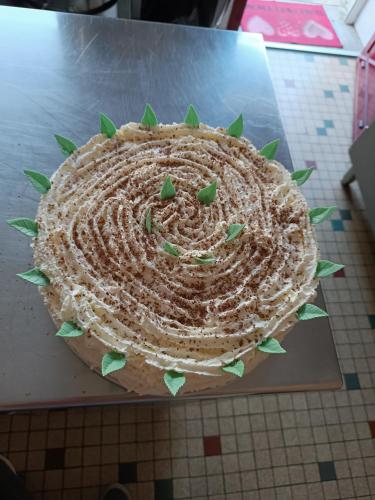 a large cake sitting on top of a table at Hôtel Le Pommeil in Guéret