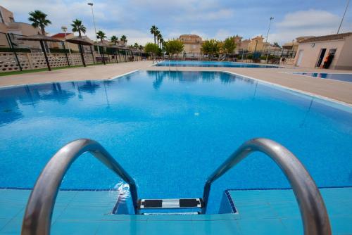 a large blue swimming pool with blue water at Holiday Beach Brissa Mar in Gran Alacant