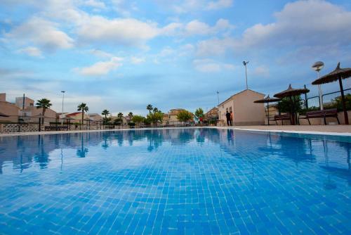 a large swimming pool with blue water at Holiday Beach Brissa Mar in Gran Alacant