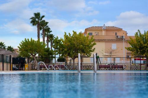 a swimming pool in front of a building at Holiday Beach Brissa Mar in Gran Alacant