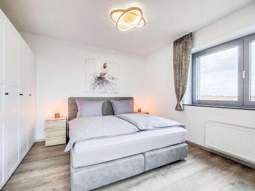 ノルダーナイにあるCornelius-03の白いベッドルーム(大型ベッド1台、窓付)