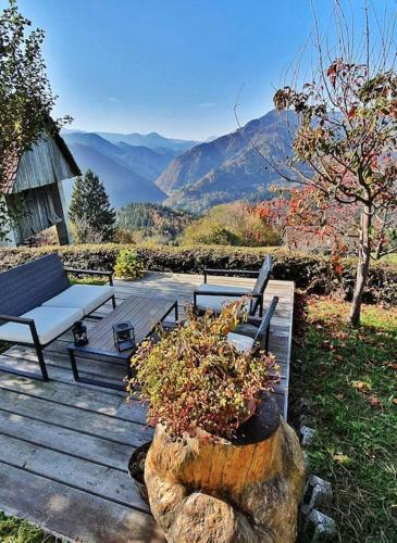 a wooden deck with a bench and a plant at House Pucnk-beautiful countryside in Železniki