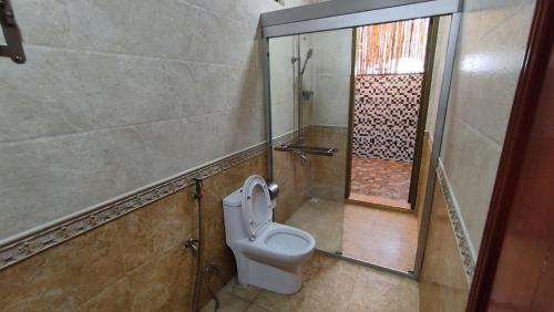 a bathroom with a toilet and a walk in shower at Rindali - The speedboat from Malé to the hotel departs at 1130 every Monday Thursday and Saturday and from the hotel to Malé at 0630 and five domestic flights are available every day in Dhaalu Atoll
