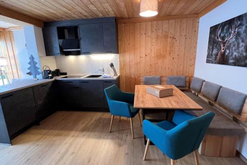 a kitchen and dining room with a table and chairs at Apartmenthaus Matri by Pferd auf Wolke in Wald am Arlberg