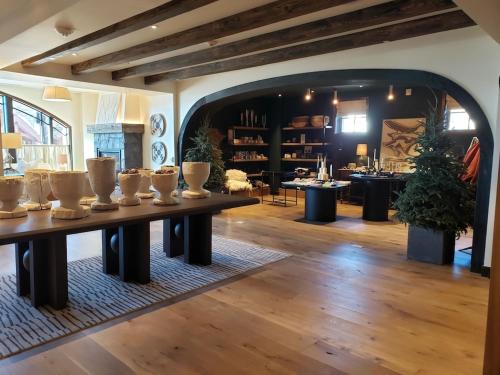 a living room with a table with vases on it at Luxury Residence at a 5 Star Hotel at the Heart of Mountain Village - Telluride in Telluride