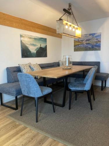 a dining room with a wooden table and chairs at Chalet 1480 in Gaschurn