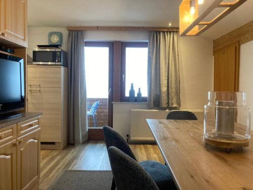 a kitchen and dining room with a table and chairs at Chalet 1480 in Gaschurn