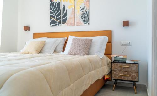 a bedroom with a large bed and a night stand at Alloggio nuovissimo al centro e rilassante in Ischia