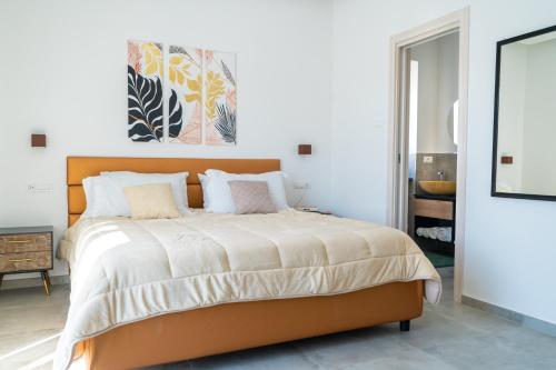 a bedroom with a large bed with an orange headboard at Alloggio nuovissimo al centro e rilassante in Ischia