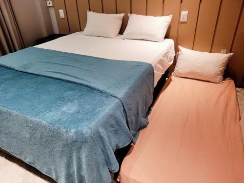 two beds sitting next to each other in a room at Flat térreo 2 quartos no Marulhos Resort - Beira mar Muro Alto in Porto De Galinhas