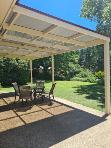 a patio with a table and chairs under a pavilion at DELANY VILLAS BRIGHT - Spa luxury on Delany Avenue in Bright