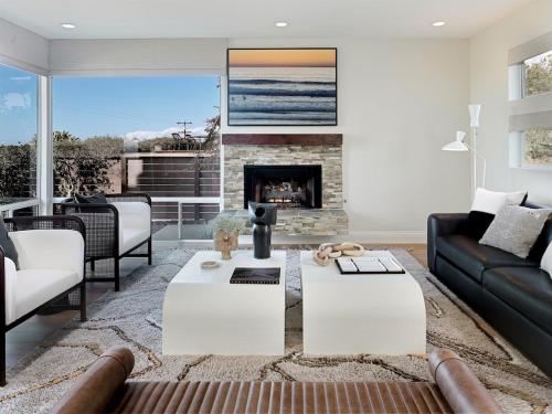 a living room with a couch and a fireplace at Grandview Getaway, Luxury 4BR, Ocean View, Fire Pit in Encinitas