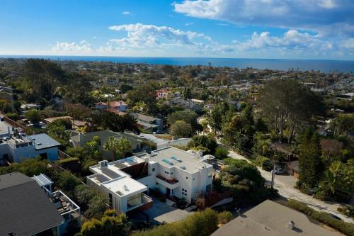 an aerial view of a city with a house and the ocean at Grandview Getaway, Luxury 4BR, Ocean View, Fire Pit in Encinitas