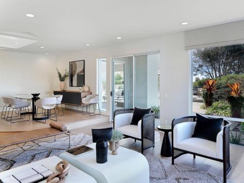 a living room with white furniture and a dining room at Grandview Getaway, Luxury 4BR, Ocean View, Fire Pit in Encinitas