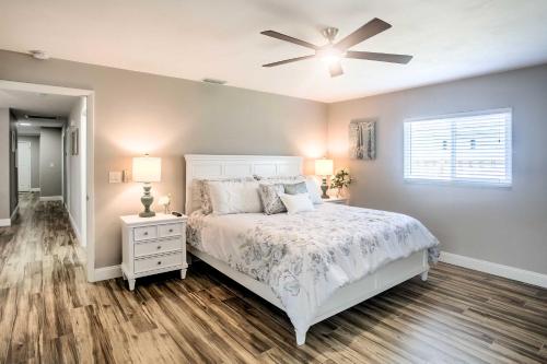 a bedroom with a white bed and a ceiling fan at Naples Home with Lanai and Pool Near Vanderbilt Beach! in Naples