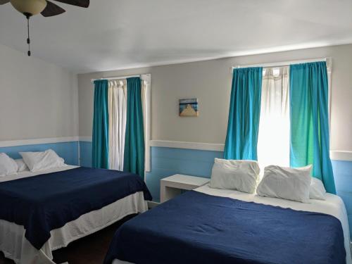 Un ou plusieurs lits dans un hébergement de l'établissement Coral Beach Village Resort