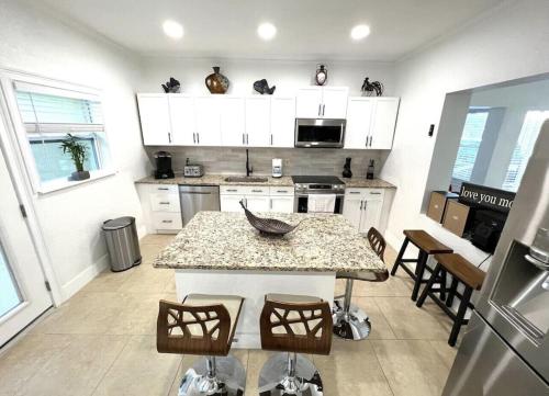 a kitchen with a table and some chairs in it at Crest Lake Beach House in Clearwater