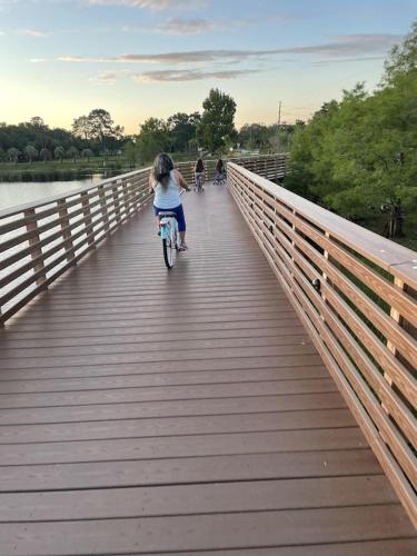 a girl riding a bike on a bridge at Crest Lake Beach House in Clearwater