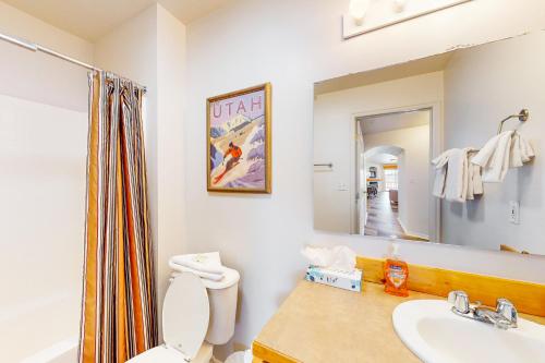 ein Badezimmer mit Toilette, Waschbecken und Spiegel in der Unterkunft Fox Bay Escape in Heber City