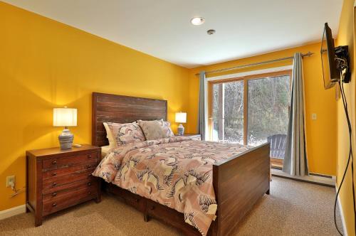 a bedroom with yellow walls and a bed and a window at The Pico Escape- 3BR 2BA Ski On Ski Off at Pico Mountain, Close to Killington, condo in Killington