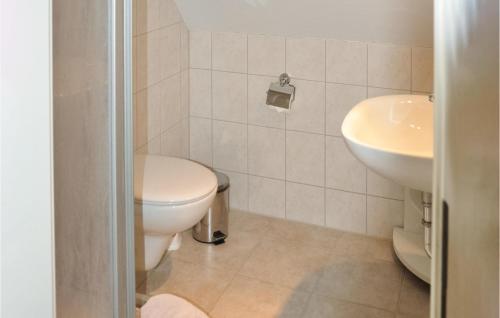 a bathroom with a toilet and a sink at Fewo Schloss Spyker in Kaschow