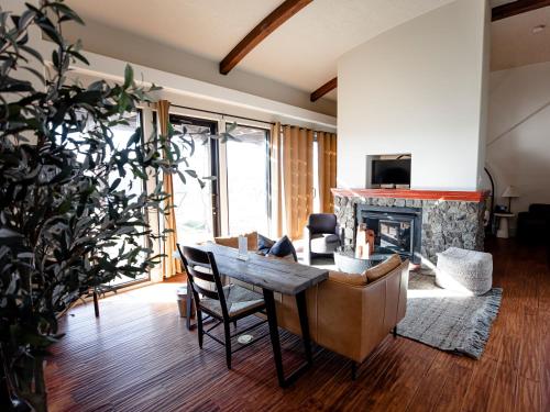 a living room with a table and a fireplace at Sagecliffe Resort & Spa in George
