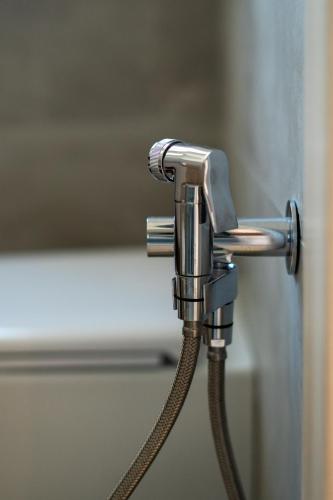 a shower head with a hose in a bathroom at Alloggio nuovissimo al centro e rilassante in Ischia