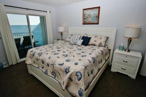 1 dormitorio con 1 cama y vistas al océano en Ocean Dunes 2006, en Kure Beach