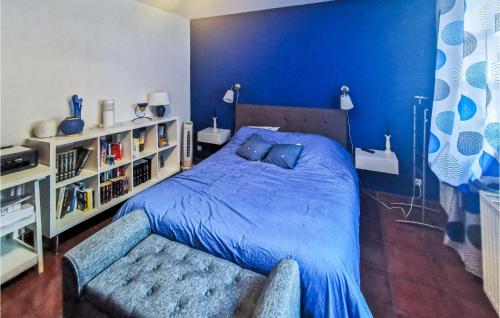 1 dormitorio azul con 1 cama con edredón azul en Gorgeous Home In Salbris With Private Swimming Pool, Can Be Inside Or Outside, en Salbris