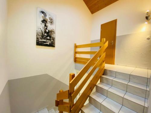 a staircase in a house with a painting on the wall at Lake View Apartment -14 in Niederried