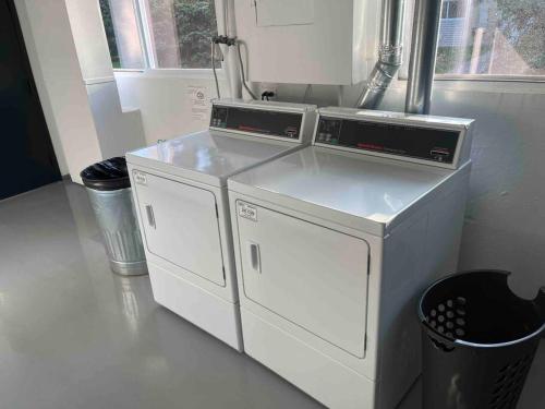 two washing machines sitting next to each other in a room at Lg. 2 br Apt. North of Chicago w/ Free Parking in Des Plaines