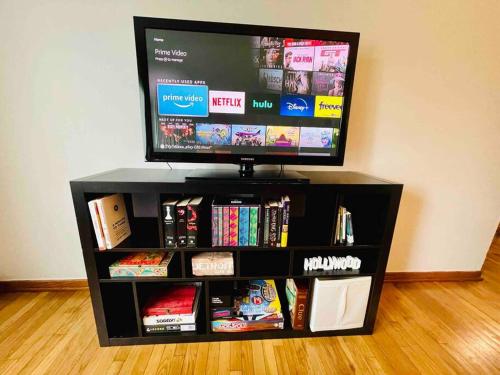 a flat screen tv sitting on top of a book shelf at Lg. 2 br Apt. North of Chicago w/ Free Parking in Des Plaines