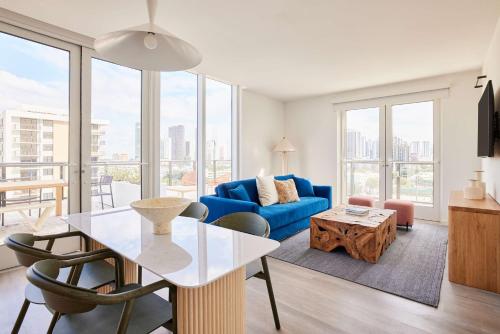 a living room with a blue couch and a table at Arlo Wynwood Miami in Miami