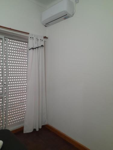 a room with a curtain and a window at Departamento Temporario Bahía Blanca pleno centro de la ciudad in Bahía Blanca
