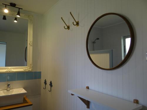 a bathroom with a sink and a mirror at Hotel Boutique La Perouse in Hanga Roa