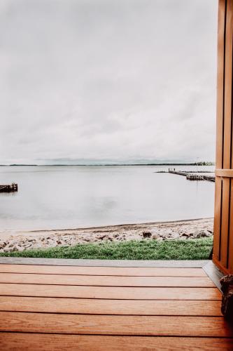 a view of a beach from a window at La Place Rendez-Vous Hotel in Fort Frances