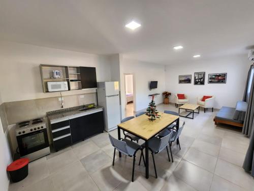 a kitchen and living room with a table and chairs at BAHIA de los PESCADORES in Paso de la Patria